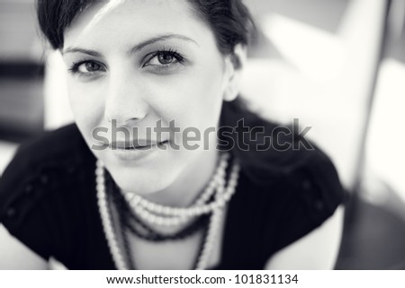 beautiful young woman portrait, close up outdoor.With pearls necklace