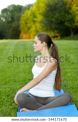 woman in outdoor doing yoga . outside on summer / spring day.