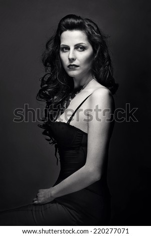 Woman with beauty long brown hair - posing at studio. Black and white