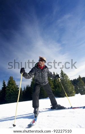 young man in black clothing skiing on mountain slope at ski resort
