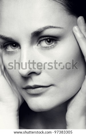 Close-up black and white portrait of beautiful woman with perfect healthy skin and natural makeup