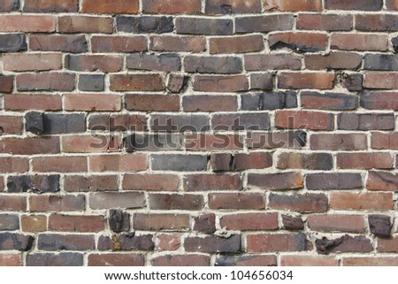 A facade comprised of warped red brick/Warped Red Brick Facade/Red brick facade that\'s warped