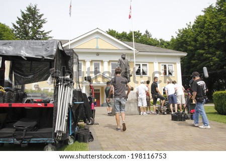 FORT LANGLEY, BC/CANADA - JUNE 11: Crew with the television series Cedar Cove set up for their next shot in front of Fort Langley\'s community hall in southern British Columbia on June 11, 2014.