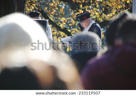 VANCOUVER, BC/CANADA: NOVEMBER 11: A retired police officer pays his respects at a Remembrance Day service in Vancouver, Canada on November 11, 2014.