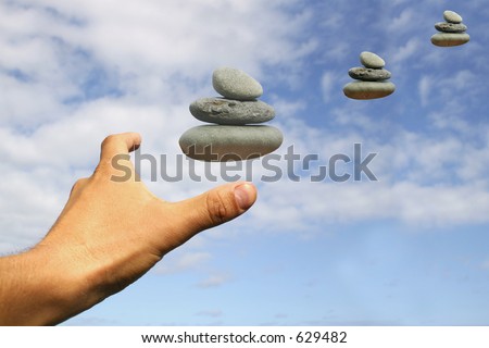 Hand reaching for or attracting pebbles; Looking for inner peace