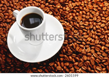 Cup of coffee on rich coffee bean background