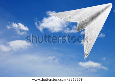 Paper aeroplane made of newspaper page in flight