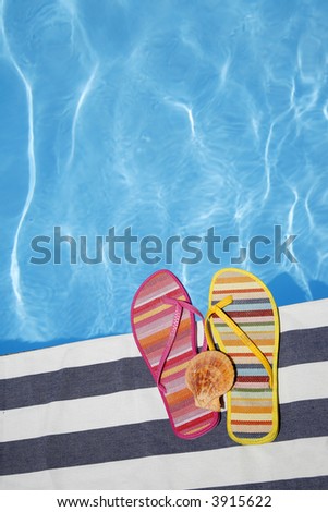 Odd summer shoes by pool with seashell