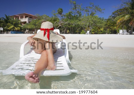 Woman sunbathing on a tropical beach