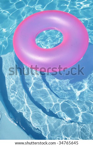 Pink floating toy floating in a blue swimming pool