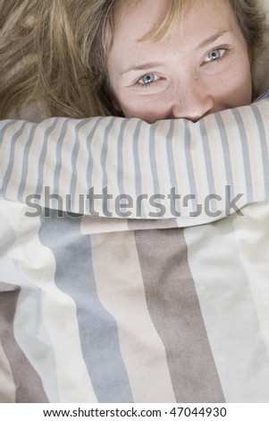 Woman in bed with a striped duvet