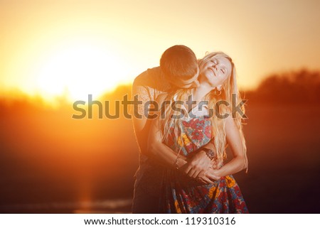 happy couple kissing on the beach