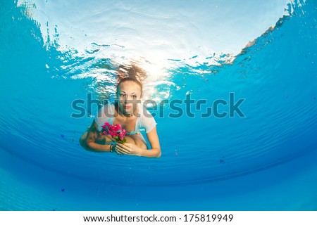 underwater portrait of girl with flowers