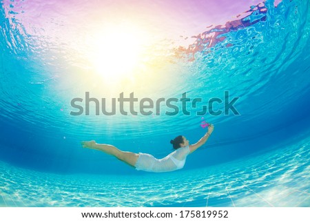 underwater swimming with flowers