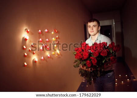 man with  rose bouquet in corridor with