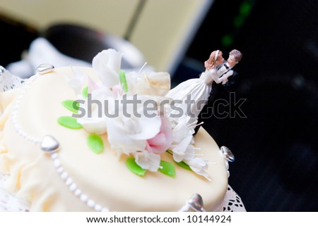 wedding cake decorated with figures of people