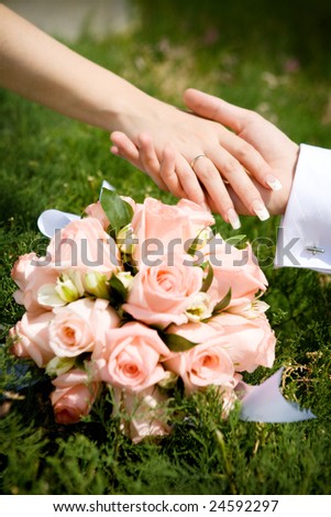 two hands over flower bouquet