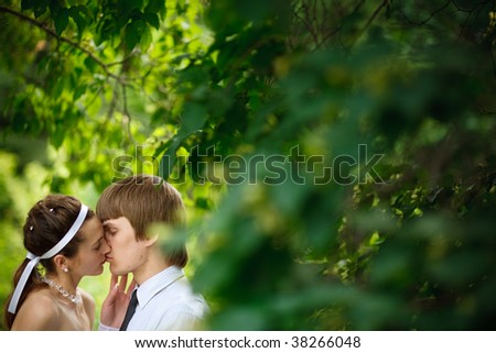 a bride and groom near the tree