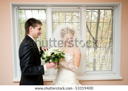 groom gives flowers to the bride