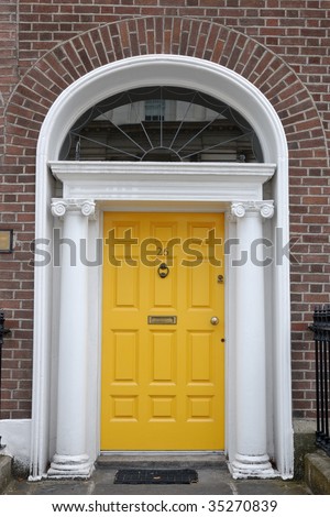 Yellow  front door in classic urban street