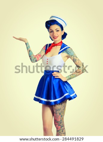 Pin-up girl sailor to his full height, hand shows a demonstrative gesture