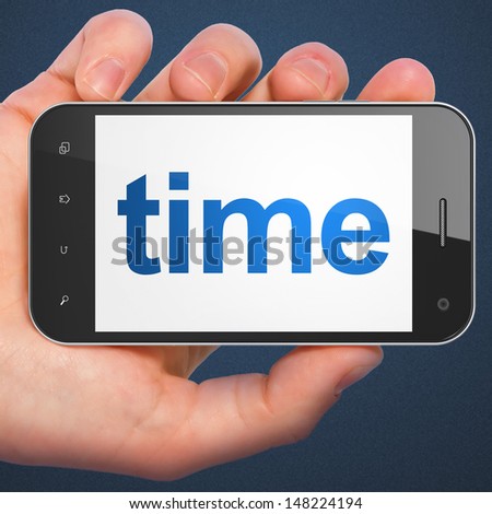 Time concept: hand holding smartphone with word Time on display. Generic mobile smart phone in hand on Dark Blue background.