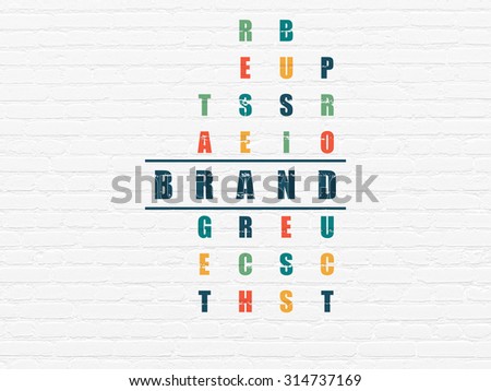 Marketing concept: Painted blue word Brand in solving Crossword Puzzle