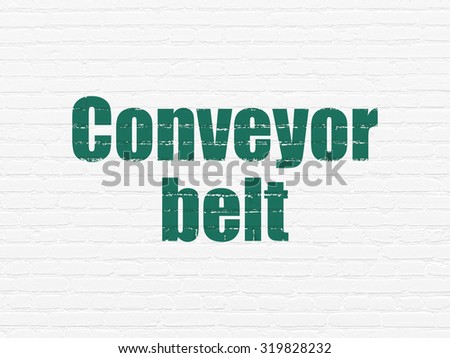 Manufacuring concept: Painted green text Conveyor Belt on White Brick wall background