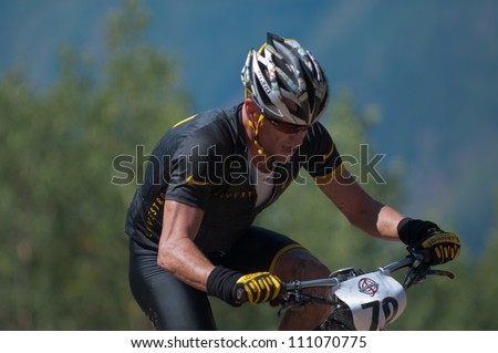 ASPEN, CO - AUG 25: Lance Armstrong climbing Aspen Mountain at the Power of Four mountain bike race in Aspen, CO on Aug 25, 2012