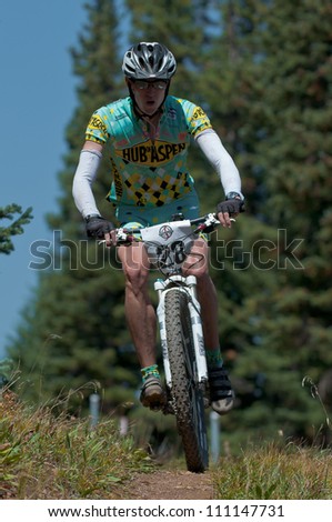 ASPEN, CO - AUG 25: Tyler Newton downhill at The Power of Four mountain bike race in Aspen, CO on Aug 25, 2012