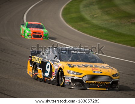 FONTANA, CA - MAR 23: Marcos Ambrose (9) drives into turn 3 at the Nascar Sprint Cup Auto Club 400 race at Auto Club Speedway in Fontana, CA on March 23, 2014