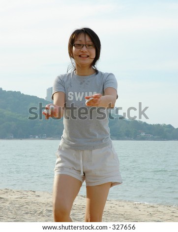 Asian girl holding sea shells in both hands