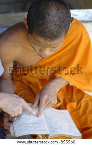 Buddhist monk reading a religious text in Luang Prabang, Laos