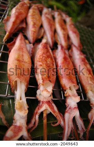 grilled cuttlefish sold by hawker in thailand