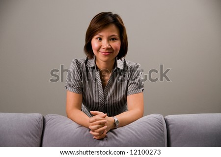 Asian lady in business attire, looking at you