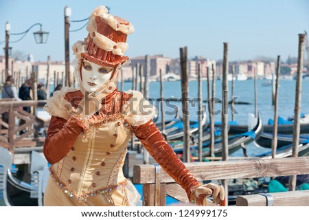 VENICE,ITALY-FEB.17: Unrecognizable person wearing carnival costume and posing along Saint Mark waterfront on February 17, 2012 in Venice, Italy. In 2012 the Carnival was held between 11-21 February.