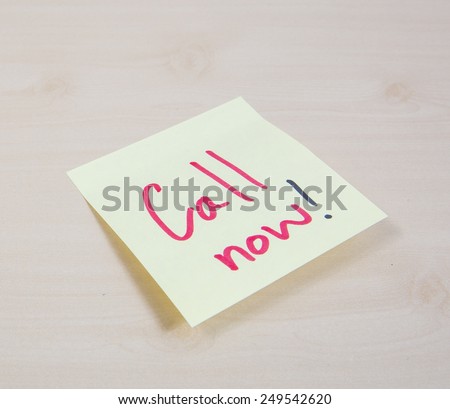 A yellow square sticky note with the words Call Me written on it.