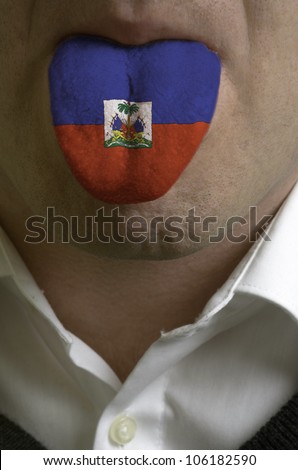 man with open mouth spreading tongue colored in haiti flag as symbol of values like teaching, learning, multilingual speaking of different languages