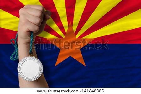 Holding silver medal for sport and flag of us state of arizona