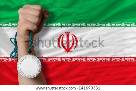 Holding silver medal for sport and national flag of iran