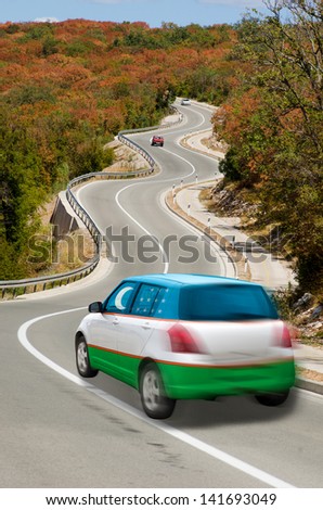 traveling car in national flag of uzbekistan colors and beautiful road landscape for tourism and touristic adertising