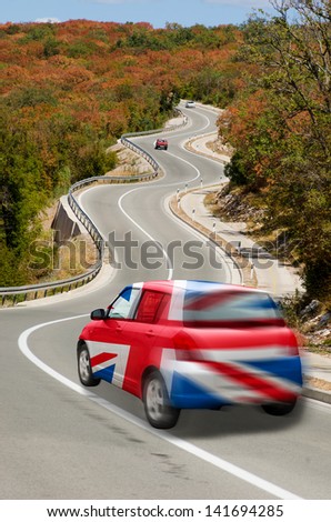 traveling car in national flag of uk colors and beautiful road landscape for tourism and touristic adertising