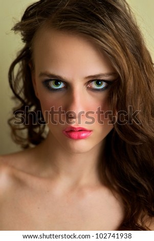 Attractive female gazing into the camera, serious expression