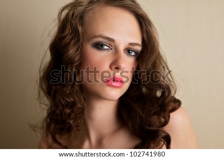 Attractive female gazing into the camera, seductive expression