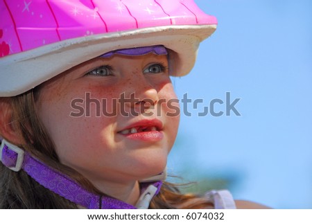 Young Girl With Missing Front Teeth Wearing Cycling Safety Helmet
