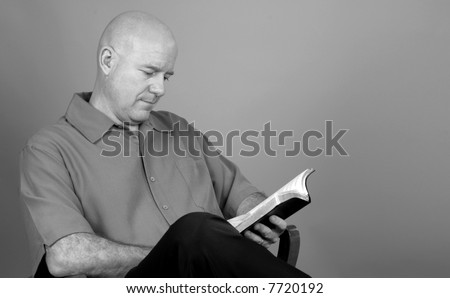 Thoughtful Man Reading Bible Book