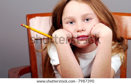 Young Girl Looking Bored Holding Pencil