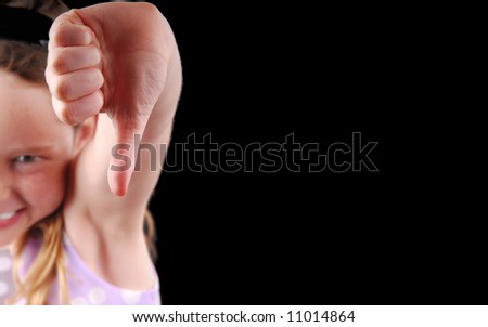 Young girl voting NO by gesturing with thumb down