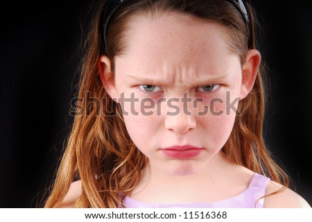 Young girl with angry or upset expression on face
