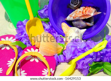Colorful array of beach objects on sand